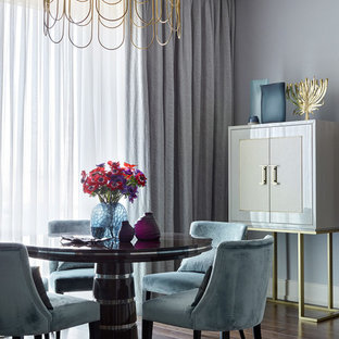 This is an example of a classic dining room in London with grey walls, dark hardwood flooring, no fireplace and brown floors.