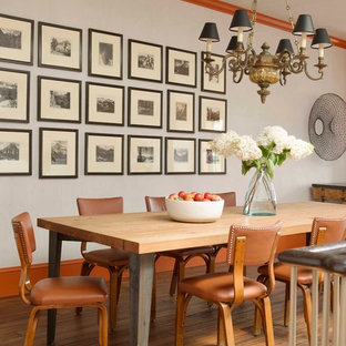 Eclectic medium tone wood floor dining room photo in New York with white walls
