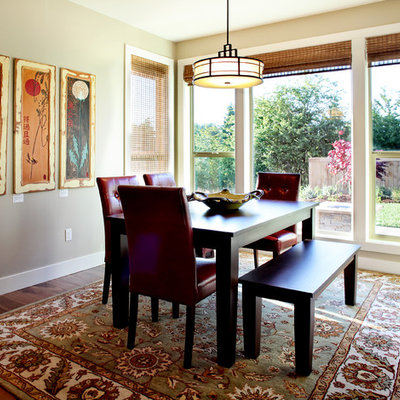 Example of a trendy dark wood floor dining room design in Portland with beige walls