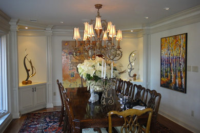 Large eclectic medium tone wood floor enclosed dining room photo in Little Rock with beige walls