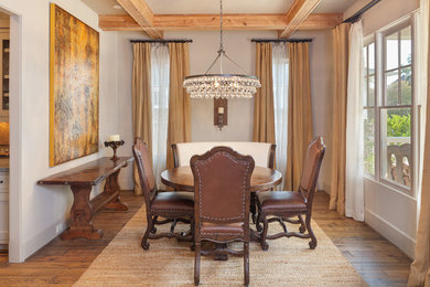 Inspiration for a medium tone wood floor enclosed dining room remodel in Houston with gray walls