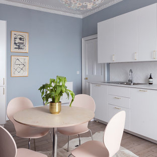 Medium sized classic kitchen/dining room in Edinburgh with light hardwood flooring, grey floors and blue walls.