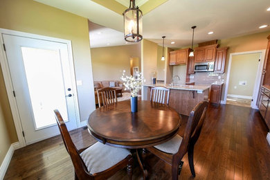 Large elegant medium tone wood floor kitchen/dining room combo photo in Toronto with beige walls and no fireplace