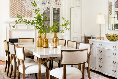 This is an example of a classic enclosed dining room in Other with white walls, a standard fireplace and medium hardwood flooring.