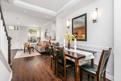 This is an example of a small traditional open plan dining room in Baltimore with grey walls, dark hardwood flooring, no fireplace and brown floors.