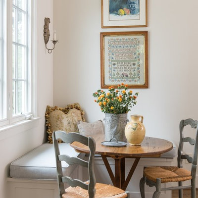 Farmhouse medium tone wood floor and brown floor dining room photo in Houston with white walls and no fireplace
