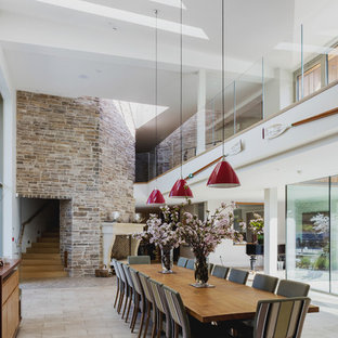 Photo of a medium sized contemporary dining room with white walls and beige floors.