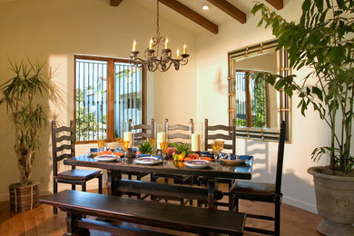 Example of a small tuscan medium tone wood floor great room design in Santa Barbara with white walls