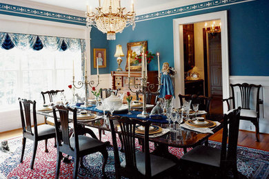 Example of a mid-sized classic dark wood floor enclosed dining room design in Charlotte with blue walls and no fireplace