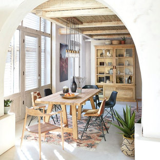 Inspiration for an eclectic enclosed dining room in London with white walls, no fireplace and beige floors.