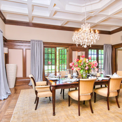 Inspiration for a large timeless medium tone wood floor enclosed dining room remodel in San Francisco with beige walls and a standard fireplace