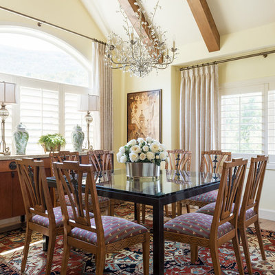 Example of a tuscan medium tone wood floor dining room design in Salt Lake City with yellow walls