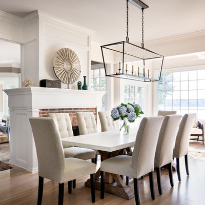 Example of a large transitional light wood floor great room design in New York with white walls, a brick fireplace and a standard fireplace
