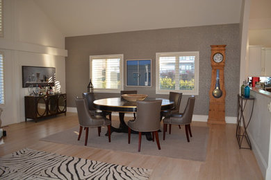 Example of a mid-sized transitional light wood floor kitchen/dining room combo design in Boston with white walls and no fireplace