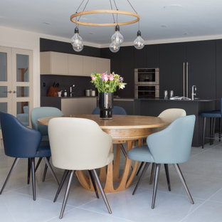 This is an example of a large contemporary kitchen/dining room in Hertfordshire with porcelain flooring, beige floors and white walls.