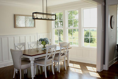 Example of a mid-sized trendy dark wood floor enclosed dining room design in Louisville with beige walls and no fireplace