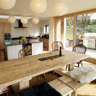 Inspiration for a medium sized farmhouse kitchen/dining room in Dorset with white walls, medium hardwood flooring and brown floors.