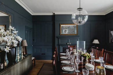 Inspiration for a medium sized classic enclosed dining room in Berkshire with medium hardwood flooring, brown floors, grey walls and feature lighting.