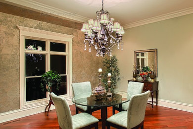 Example of a classic dining room design in Chicago with green walls