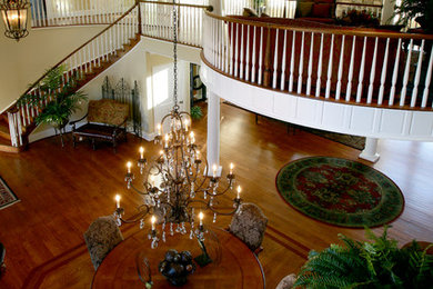Inspiration for a large timeless medium tone wood floor great room remodel in Wilmington with beige walls and no fireplace
