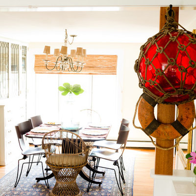 Example of a beach style medium tone wood floor dining room design in Portland Maine