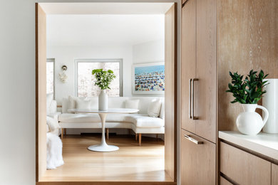 Example of a mid-sized trendy beige floor great room design in New York with white walls