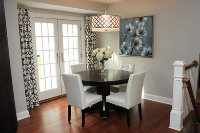 Example of a transitional dark wood floor dining room design in Detroit with gray walls
