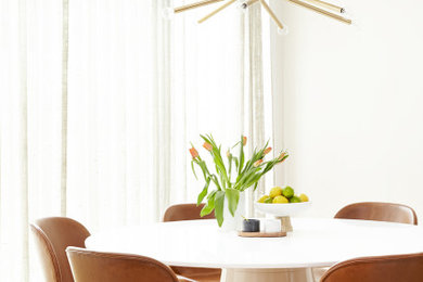 Example of a mid-sized trendy light wood floor and beige floor dining room design in Philadelphia with white walls