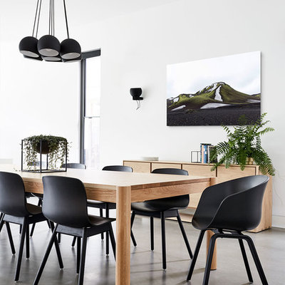 Example of a trendy concrete floor and gray floor enclosed dining room design in Melbourne with white walls