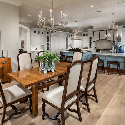 Elegant medium tone wood floor kitchen/dining room combo photo in Los Angeles with gray walls