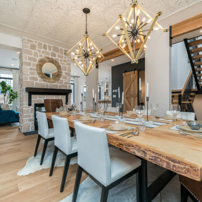 Large cottage light wood floor kitchen/dining room combo photo in Toronto with white walls, a standard fireplace and a stone fireplace
