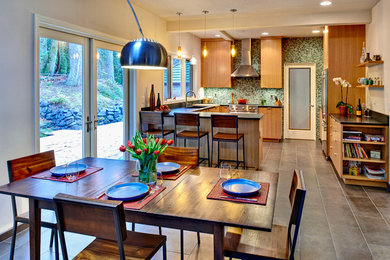 Immagine di una sala da pranzo aperta verso la cucina minimalista con pareti beige e pavimento in gres porcellanato