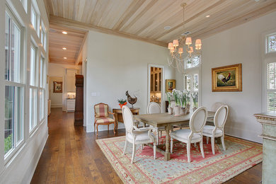 Example of a mid-sized french country dark wood floor enclosed dining room design in New Orleans with white walls and no fireplace