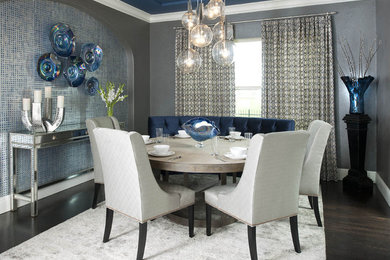 This is an example of a contemporary dining room in Dallas with grey walls and dark hardwood flooring.