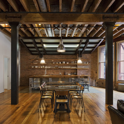 Great room - mid-sized industrial medium tone wood floor great room idea in New York with multicolored walls