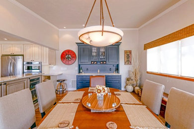 Mid-sized elegant medium tone wood floor kitchen/dining room combo photo in Denver with beige walls