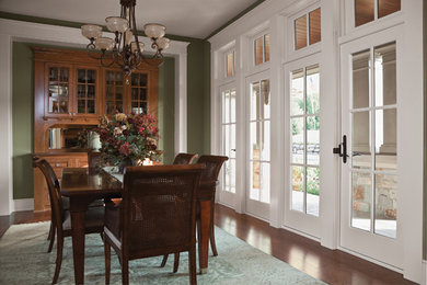 Example of a mid-sized classic dark wood floor and brown floor enclosed dining room design in Other with green walls and no fireplace