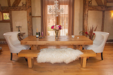 Great room - large rustic medium tone wood floor great room idea in Sussex with beige walls and no fireplace