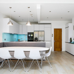 Inspiration for a small contemporary open plan dining room in London with beige floors, white walls, light hardwood flooring and no fireplace.