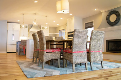Example of a beach style light wood floor kitchen/dining room combo design in Other with gray walls