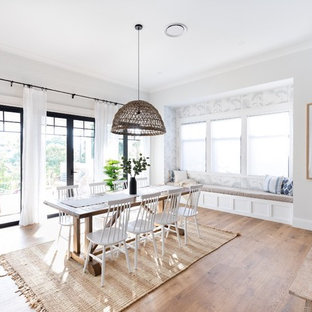 Design ideas for a country open plan dining in Brisbane with white walls, medium hardwood floors and brown floor.