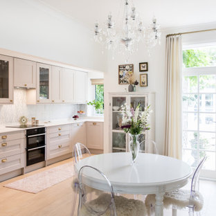 Photo of a medium sized classic kitchen/dining room in London with white walls, light hardwood flooring, no fireplace and beige floors.