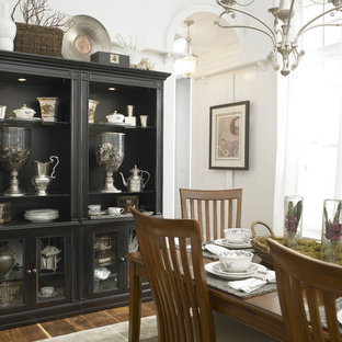 Example of an eclectic dark wood floor dining room design in Charlotte with white walls