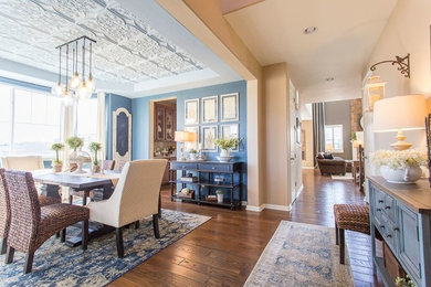 Example of a mid-sized transitional medium tone wood floor and brown floor kitchen/dining room combo design in Denver with blue walls and no fireplace