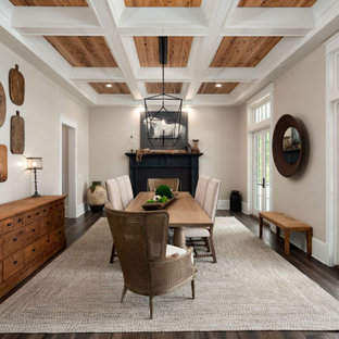 Idee per una sala da pranzo country con pareti beige, parquet scuro, camino classico, pavimento marrone e soffitto a cassettoni