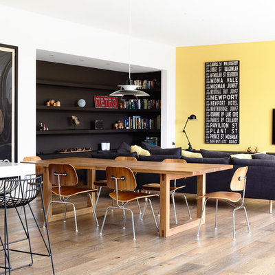 Great room - mid-sized contemporary medium tone wood floor great room idea in Melbourne with yellow walls