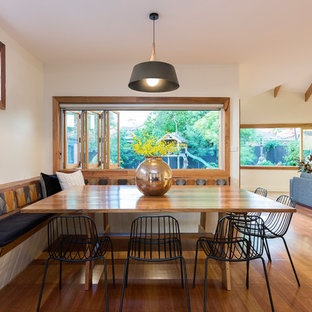 Inspiration for a large midcentury open plan dining in Melbourne with white walls, medium hardwood floors and brown floor.