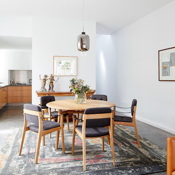 Global urban style dining room with custom rug