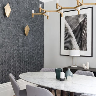 This is an example of a contemporary dining room in Cornwall with grey walls, dark hardwood flooring and brown floors.