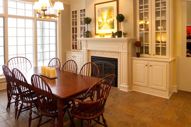 Kitchen/dining room combo - traditional kitchen/dining room combo idea in New York with white walls and a standard fireplace